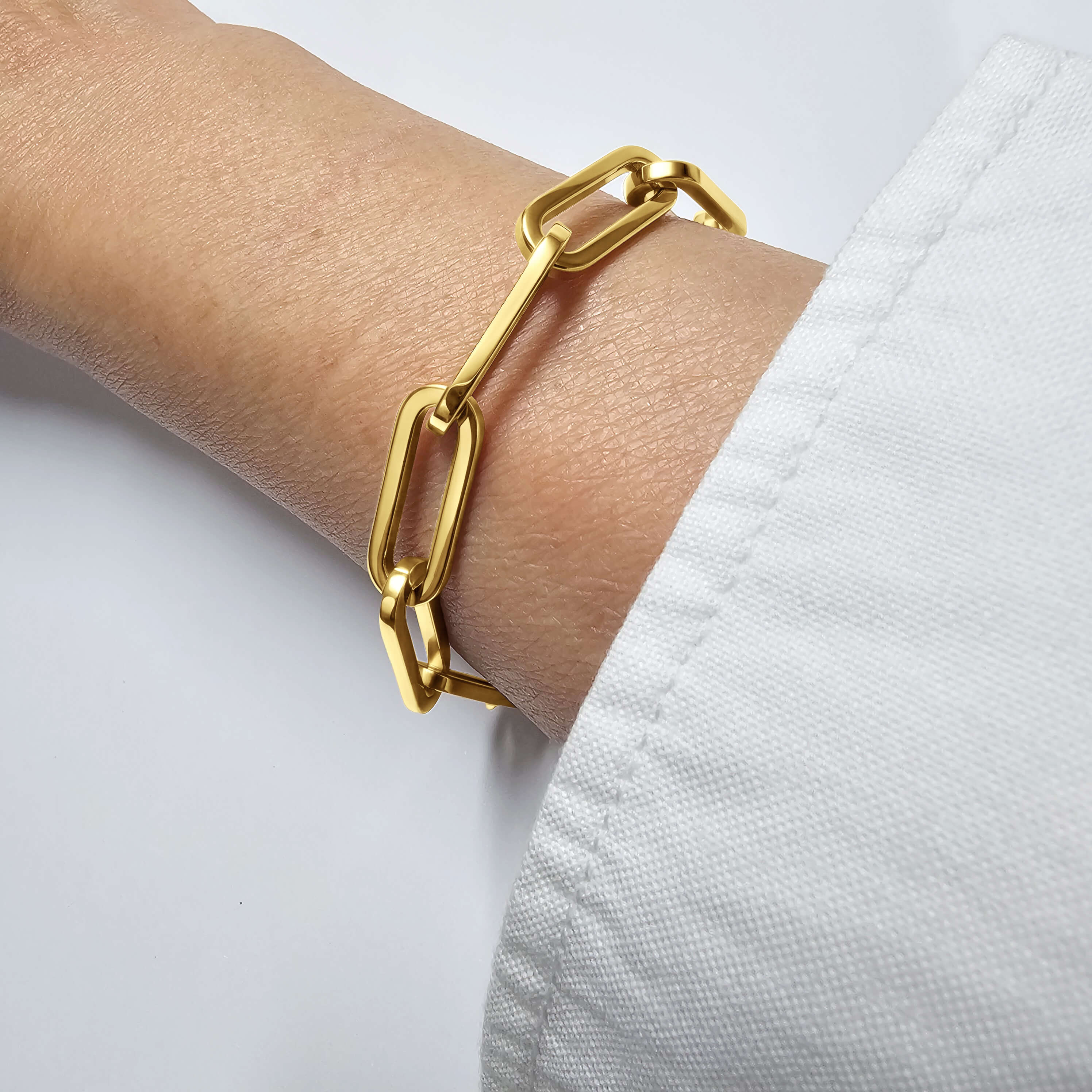 RALLUNA Sculptural Paperclip Chain Bracelet in gold-tone 316 stainless steel on a model's wrist against a clean white background