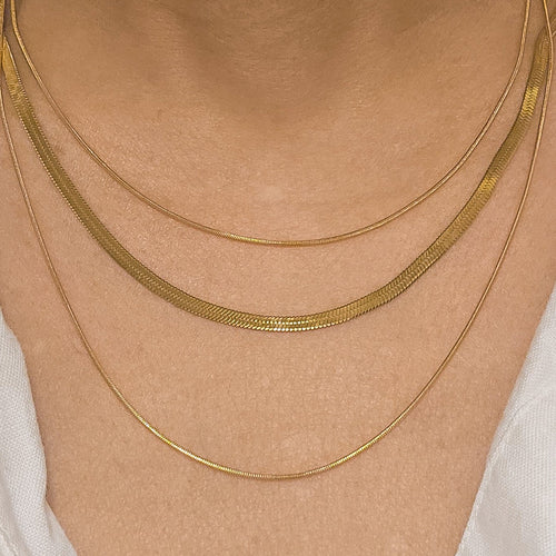 Ralluna triple layer 18k gold plated necklace on model wearing white shirt